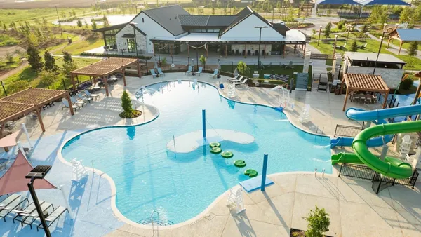 an aerial view of a house outdoor space and swimming pool
