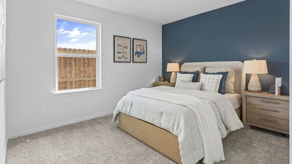 a bedroom with a bed and night stand