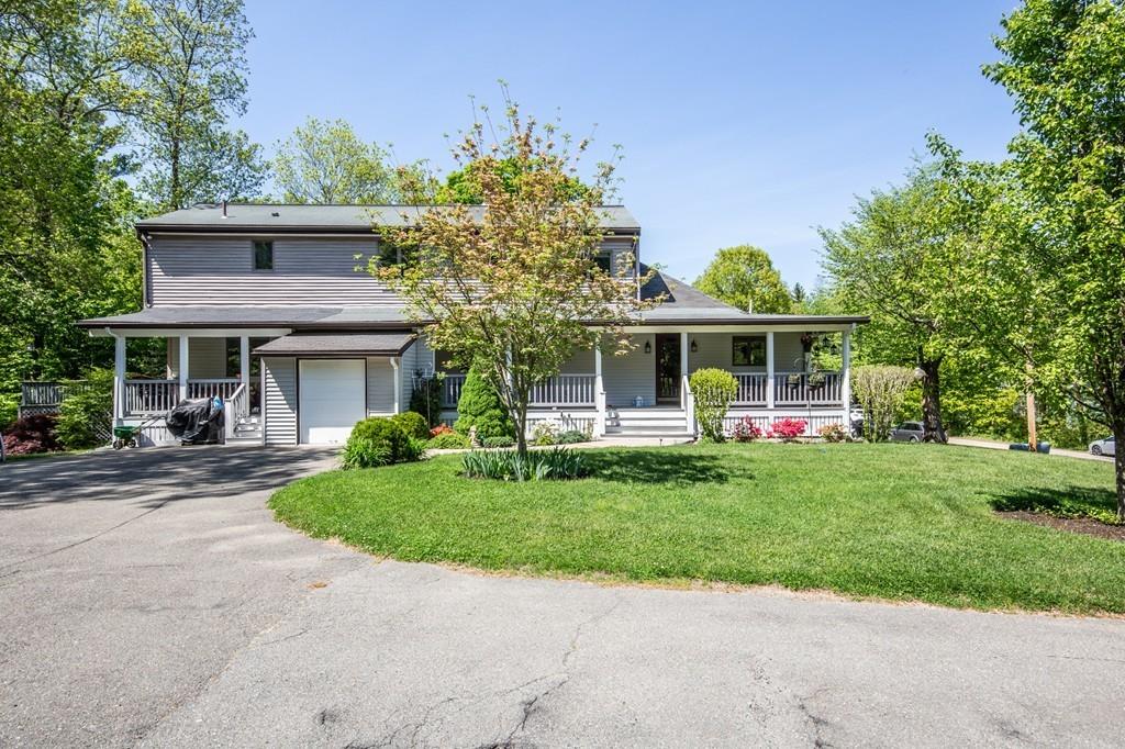 300 Locust Street Danvers, MA 01923 - Photo 3 of 41 a front view of a house with a garden and trees