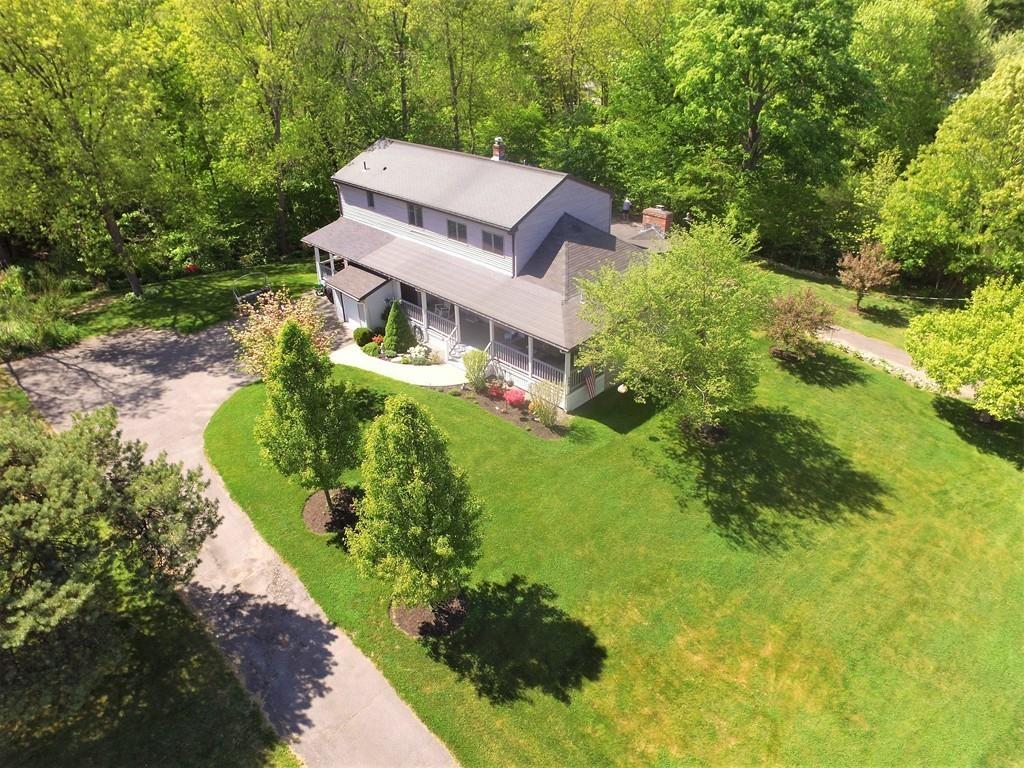 300 Locust Street Danvers, MA 01923 - Photo 4 of 41 an aerial view of a house with a garden and trees