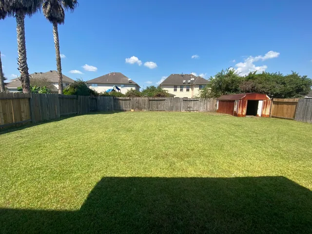 a view of a swimming pool with a yard