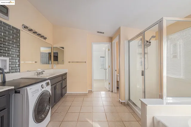 a bathroom with a sink a washer and dryer