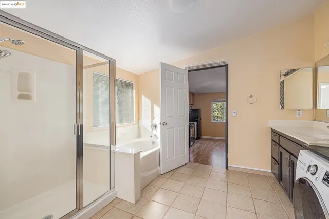 a view of a kitchen with refrigerator and sink