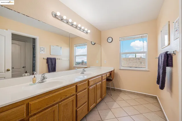 a bathroom with a double vanity sink a mirror a and a shower