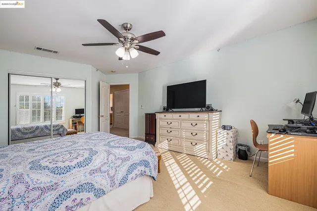 a bedroom with a bed and flat screen tv
