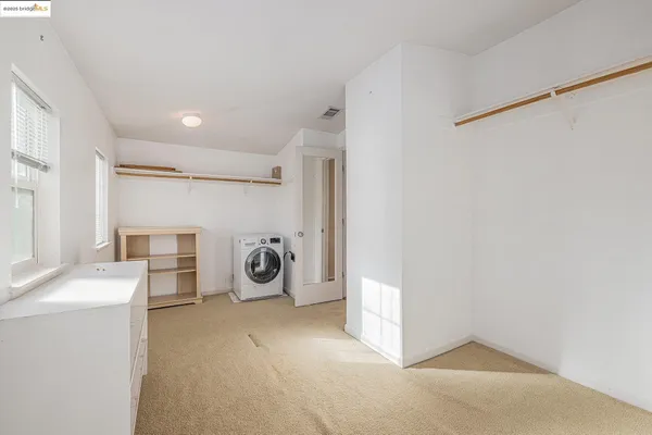 a bedroom with bed window and a flat screen tv