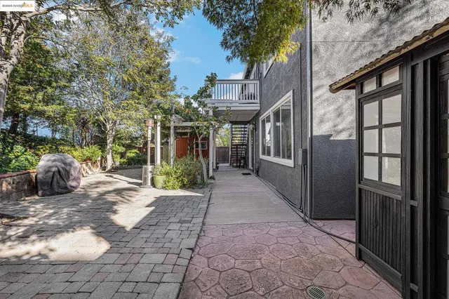 a view of a house with backyard and sitting area