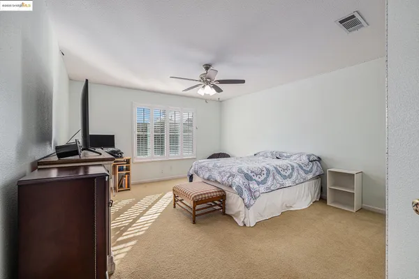 a bedroom with a bed and flat screen tv