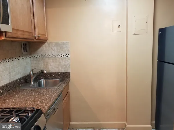 a kitchen with a sink and a refrigerator