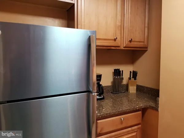 a kitchen with a refrigerator and cabinets
