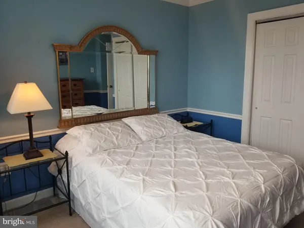 a bedroom with a bed and a table