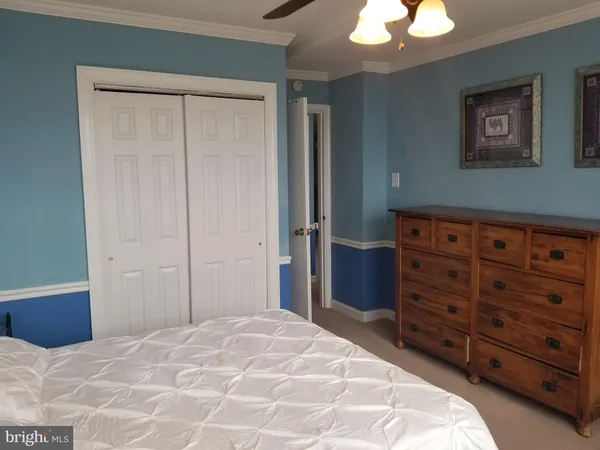 a bedroom with a bed and a dresser