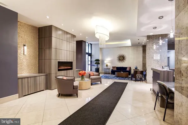 a living room with furniture a fireplace and a large window