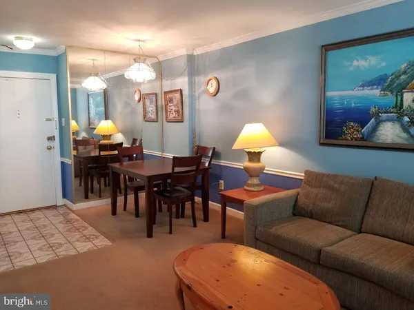a living room with furniture a chandelier and a dining table