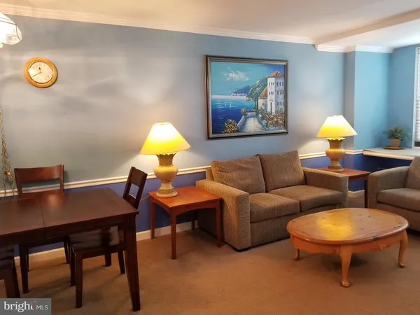 a living room with furniture a table and a lamp