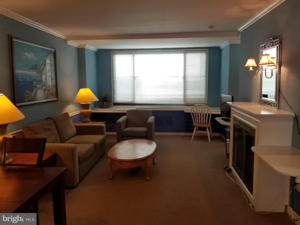 a living room with furniture a lamp and a window