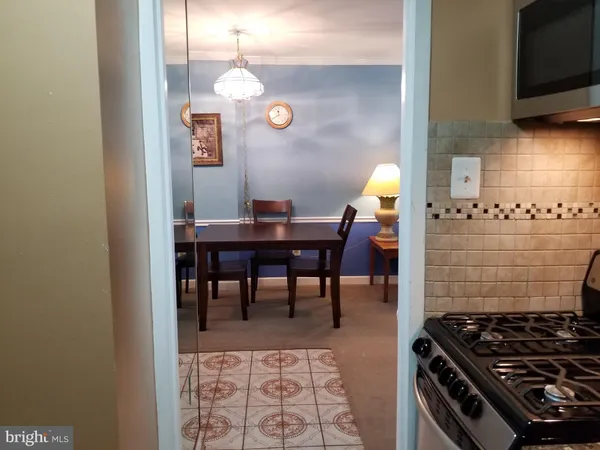 a kitchen with a stove and a dining table
