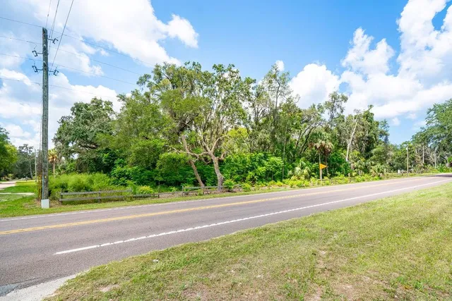 a view of a yard with wooden fence