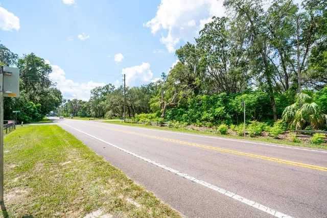 a wooden bench sitting in the middle of a yard