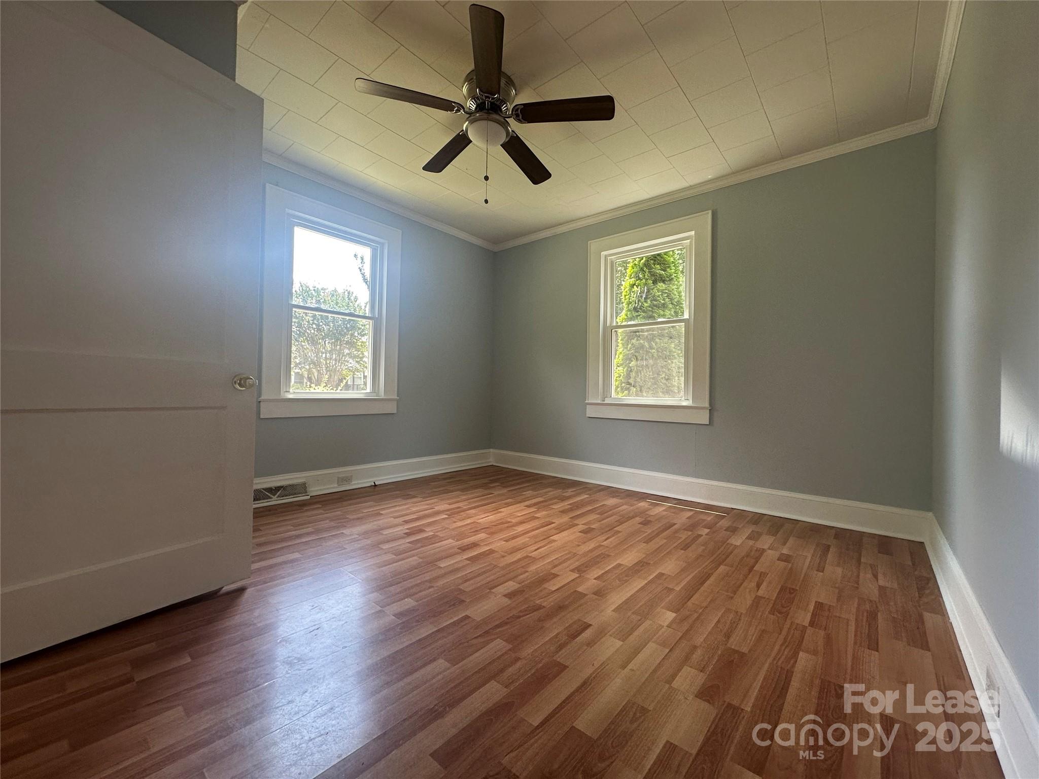 128 Market Road Mooresville, NC 28115 - Photo 14 of 20 a view of an empty room with a window and wooden floor