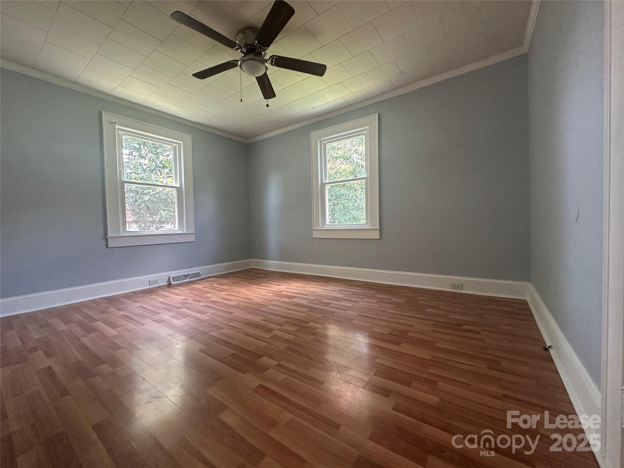 128 Market Road Mooresville, NC 28115 - Photo 15 of 20 a view of an empty room with wooden floor and a window