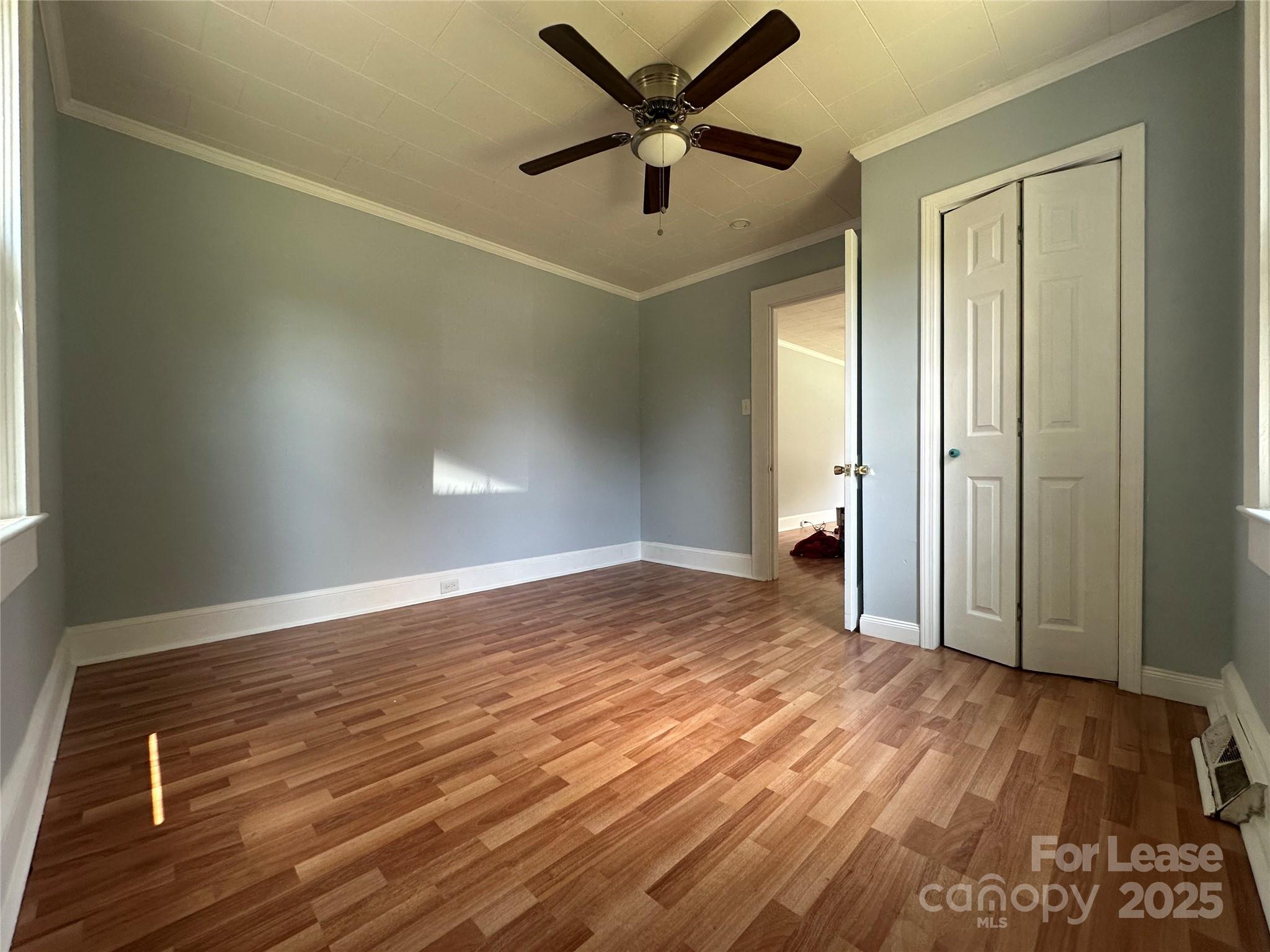 128 Market Road Mooresville, NC 28115 - Photo 16 of 20 a view of a livingroom with a ceiling fan and wooden floor