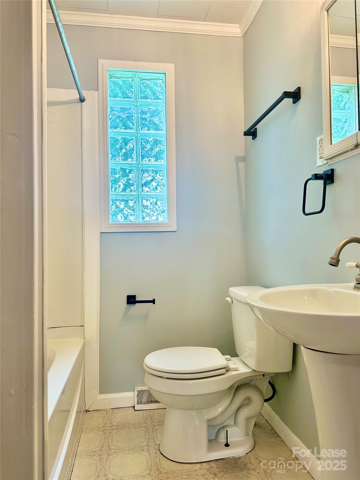 128 Market Road Mooresville, NC 28115 - Photo 17 of 20 a bathroom with a toilet a sink and a window