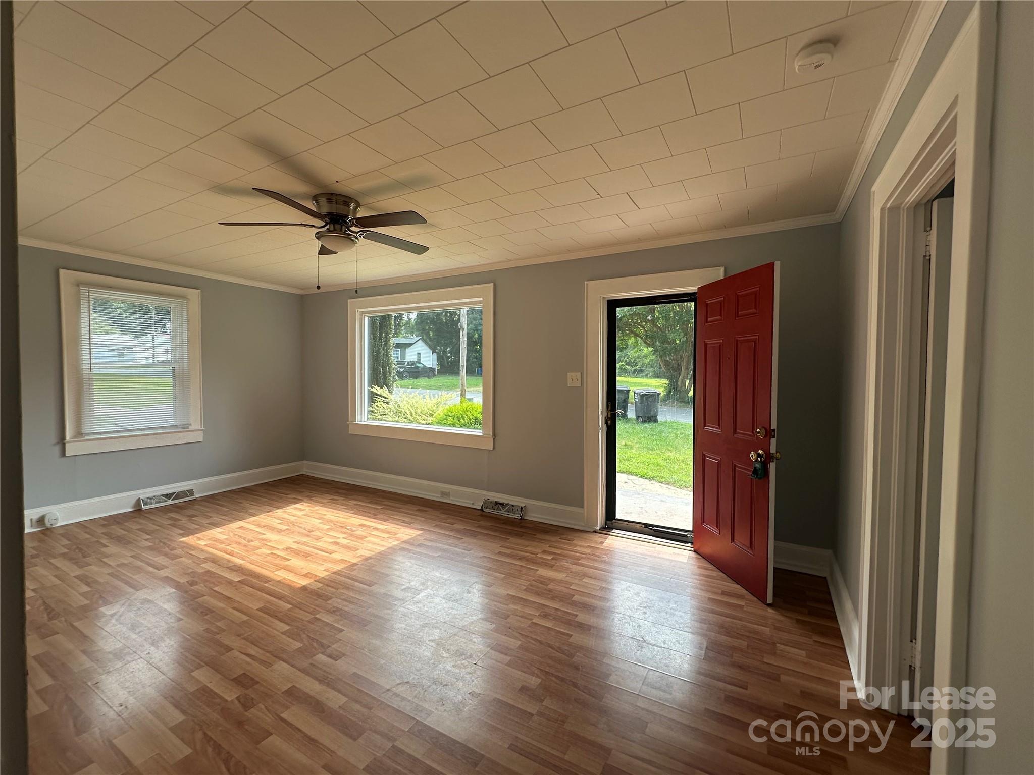 128 Market Road Mooresville, NC 28115 - Photo 4 of 20 a view of an empty room with a window and wooden floor