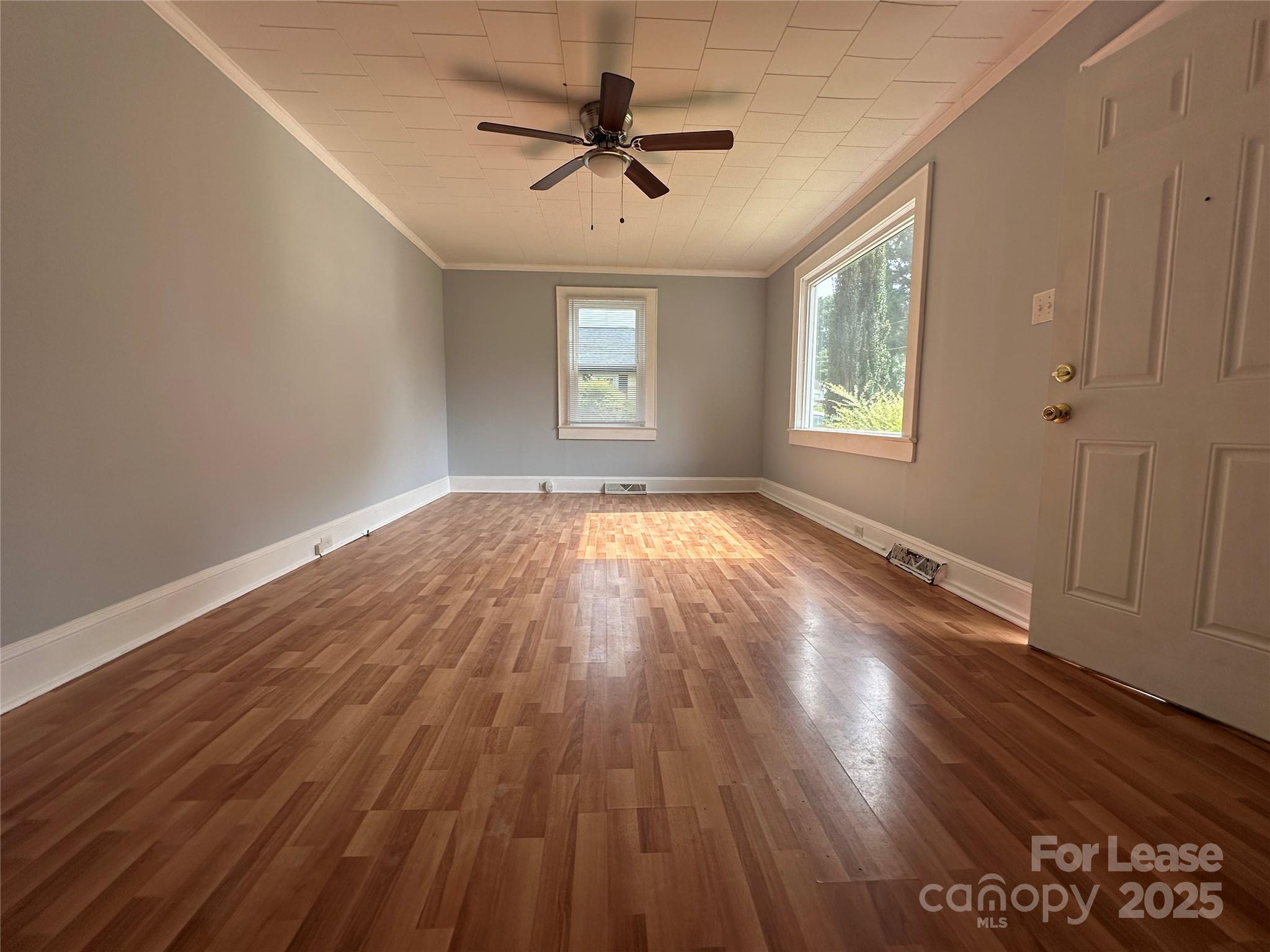 128 Market Road Mooresville, NC 28115 - Photo 6 of 20 an empty room with wooden floor and windows