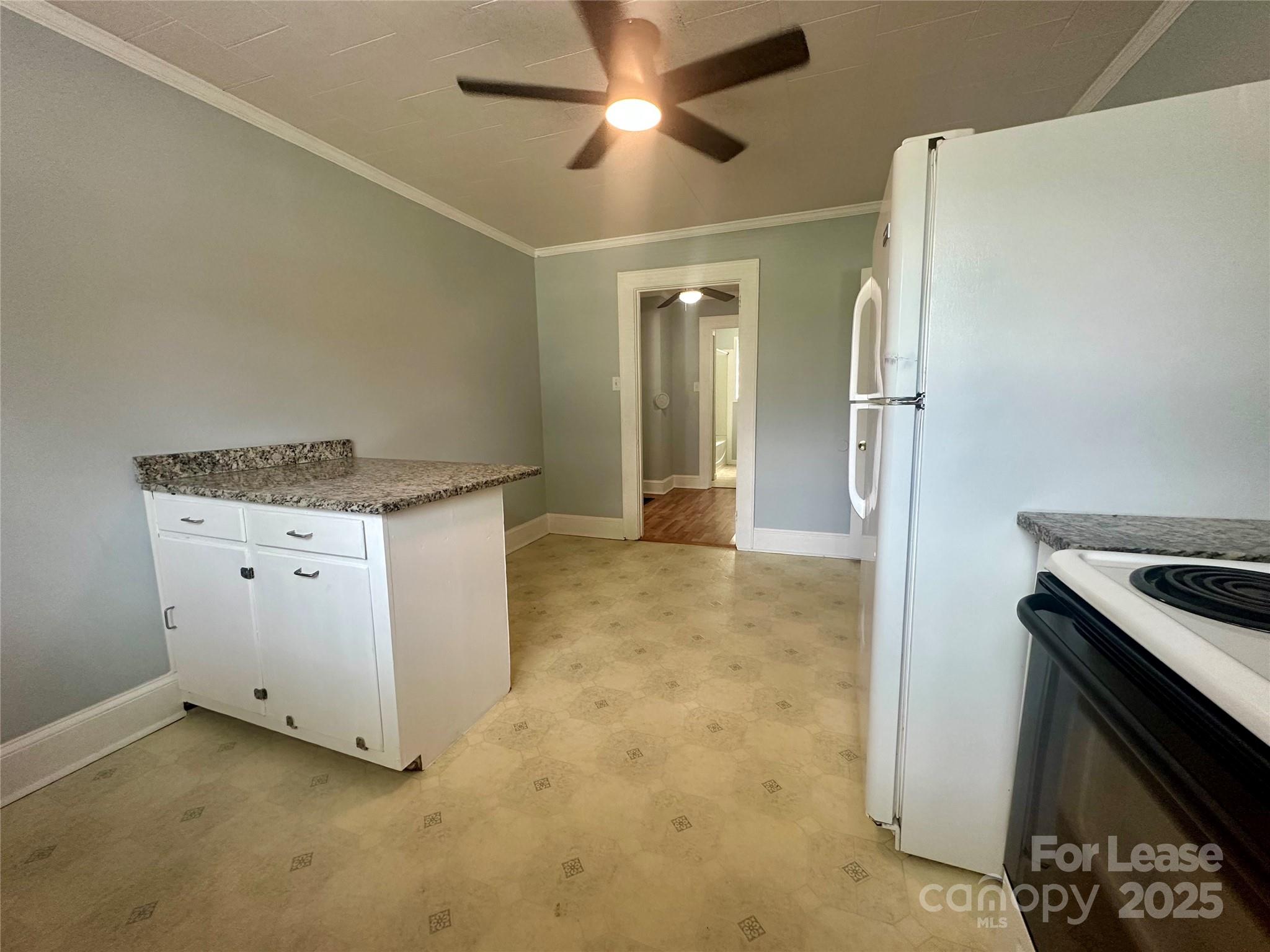 128 Market Road Mooresville, NC 28115 - Photo 10 of 20 a kitchen with a stove and a refrigerator