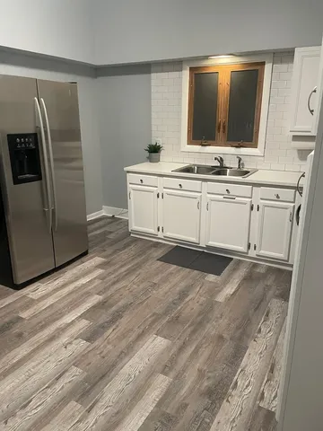 a view of cabinets with stainless steel appliances wooden floor