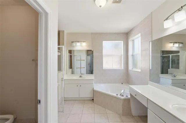 a bathroom with a tub sink and a mirror