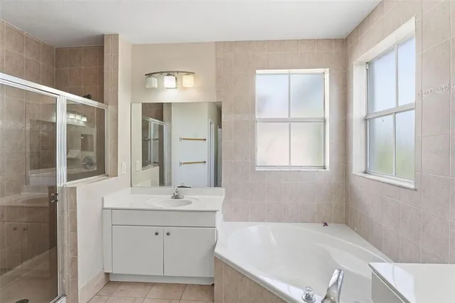 a bathroom with a bathtub and shower