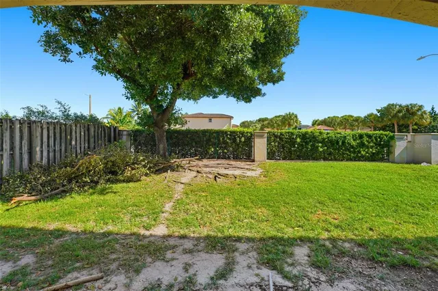 a view of backyard of house with green space