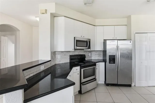 a kitchen with granite countertop a sink and a window