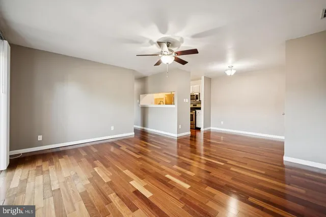 a view of empty room with wooden floor