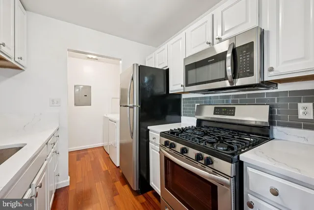a kitchen with stainless steel appliances a stove a microwave and a refrigerator