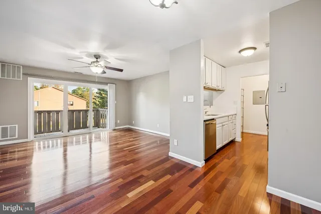a view of a kitchen with wooden floor and a kitchen
