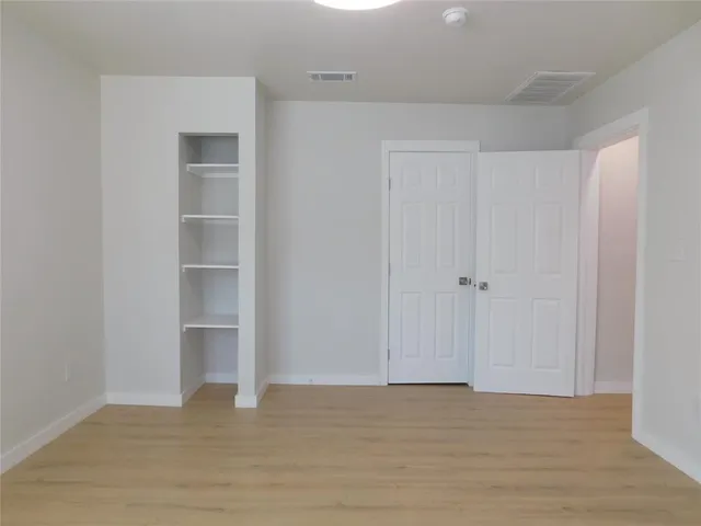 a view of a livingroom with an empty space and windows