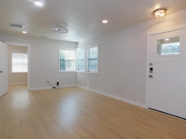 a kitchen with granite countertop a refrigerator and a stove top oven