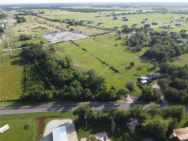 an aerial view of beach and residential houses with outdoor space