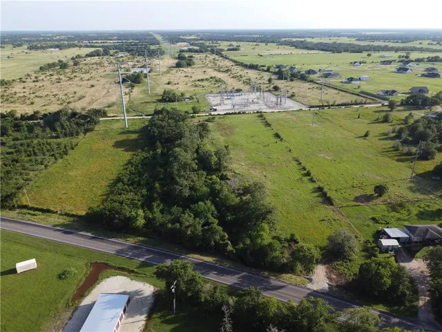an aerial view of ocean with residential house and lake view