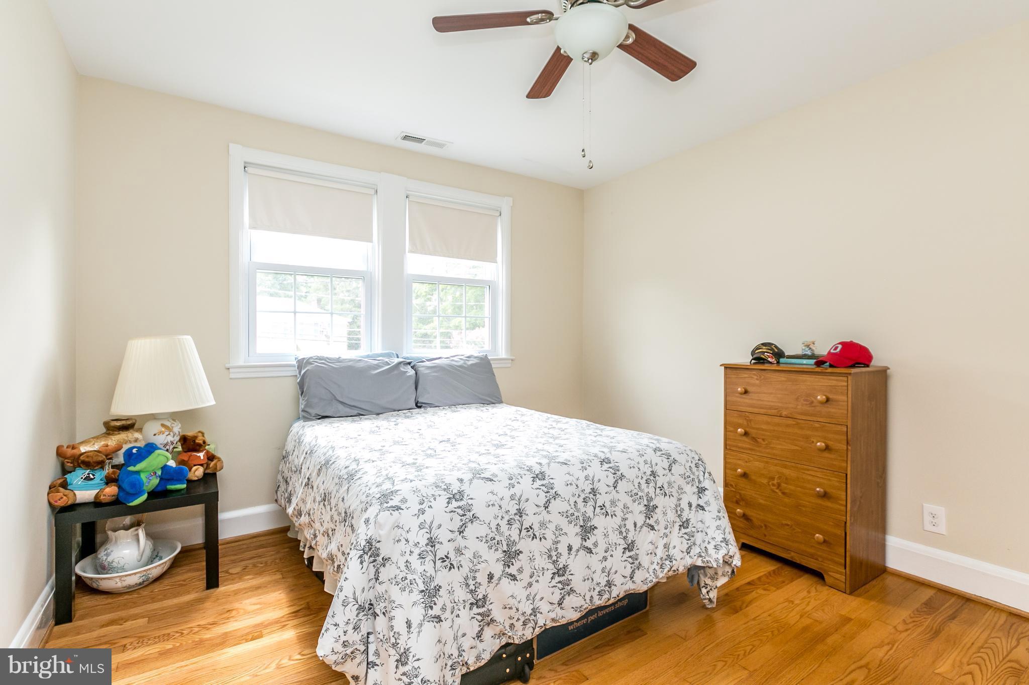 215 Dumbarton Road Baltimore, MD 21212 - Photo 15 of 30 a bedroom with a bed and wooden floor