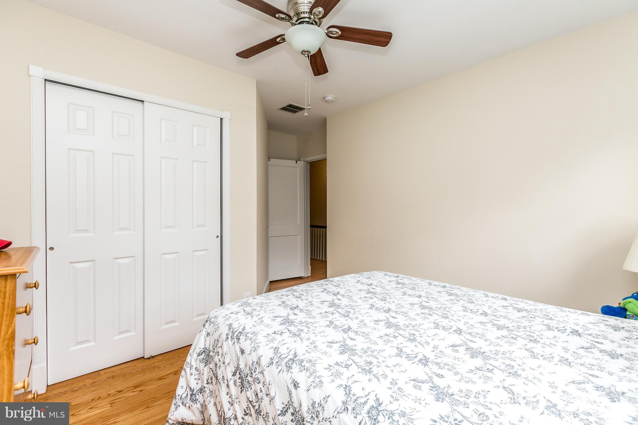 215 Dumbarton Road Baltimore, MD 21212 - Photo 17 of 30 a bedroom with a bed and a chandelier