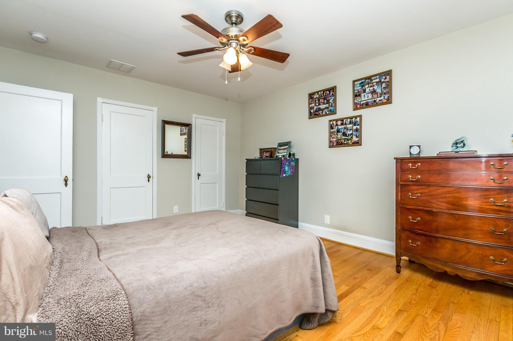 215 Dumbarton Road Baltimore, MD 21212 - Photo 18 of 30 a bedroom with a bed and a dresser