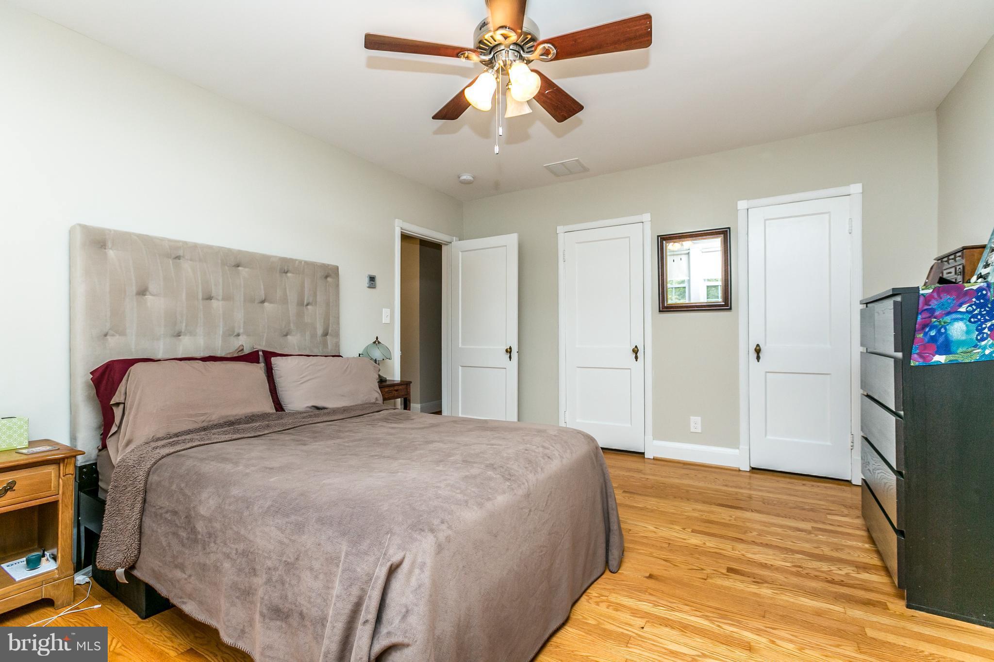 215 Dumbarton Road Baltimore, MD 21212 - Photo 19 of 30 a bedroom with a bed and a chandelier