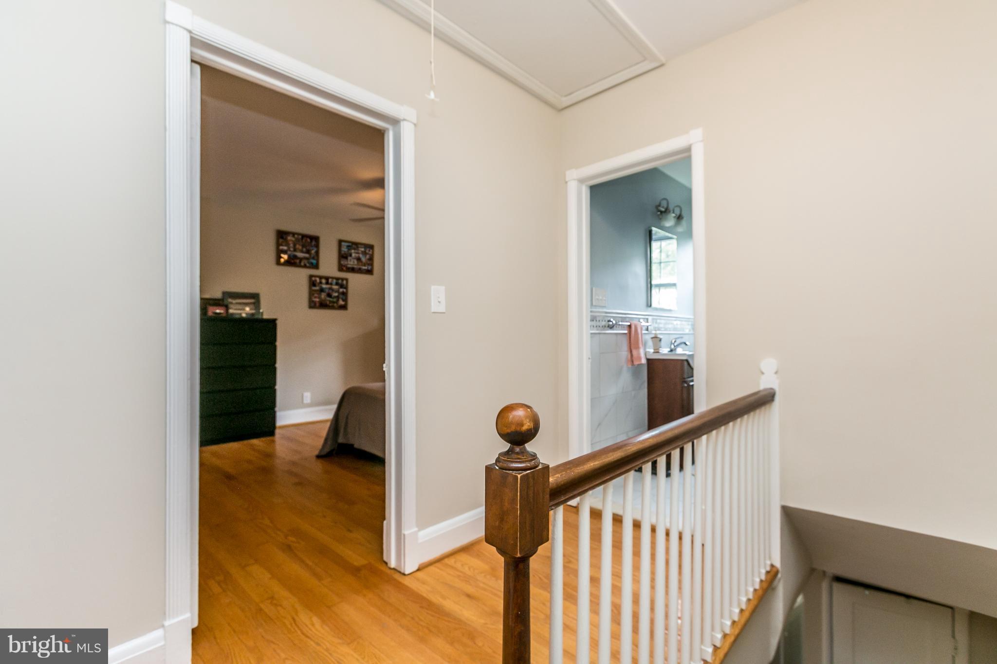 215 Dumbarton Road Baltimore, MD 21212 - Photo 20 of 30 a view of a hallway to a room with wooden floor and stairs