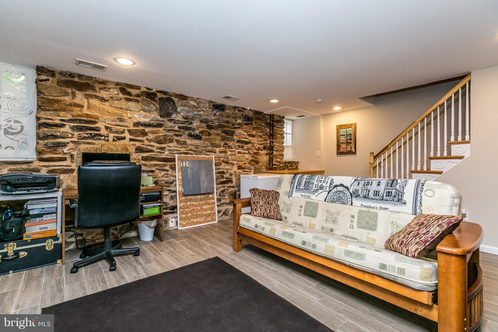 215 Dumbarton Road Baltimore, MD 21212 - Photo 27 of 30 a living room with fireplace furniture and a flat screen tv