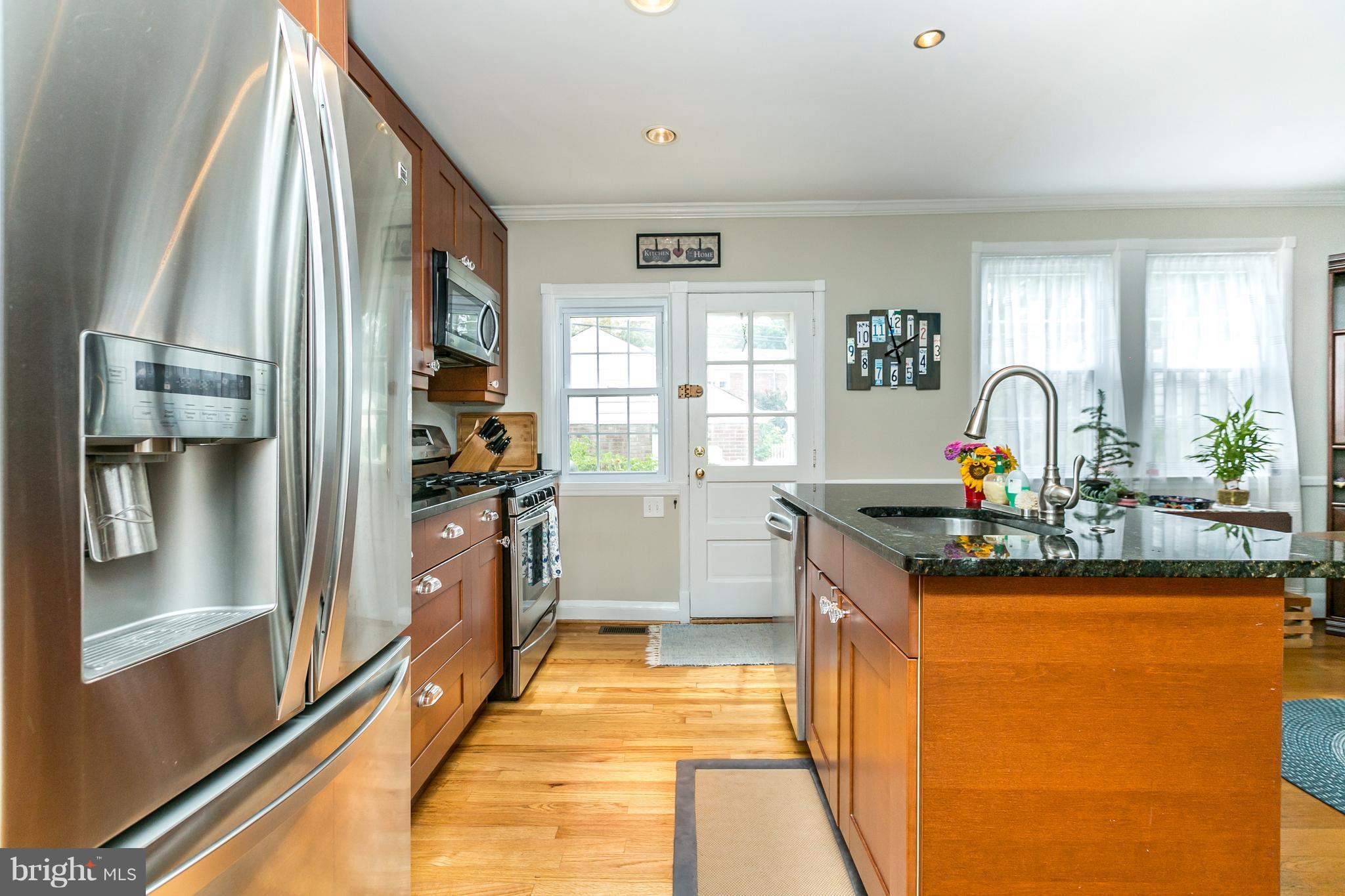 215 Dumbarton Road Baltimore, MD 21212 - Photo 10 of 30 a kitchen with stainless steel appliances granite countertop a sink and a refrigerator
