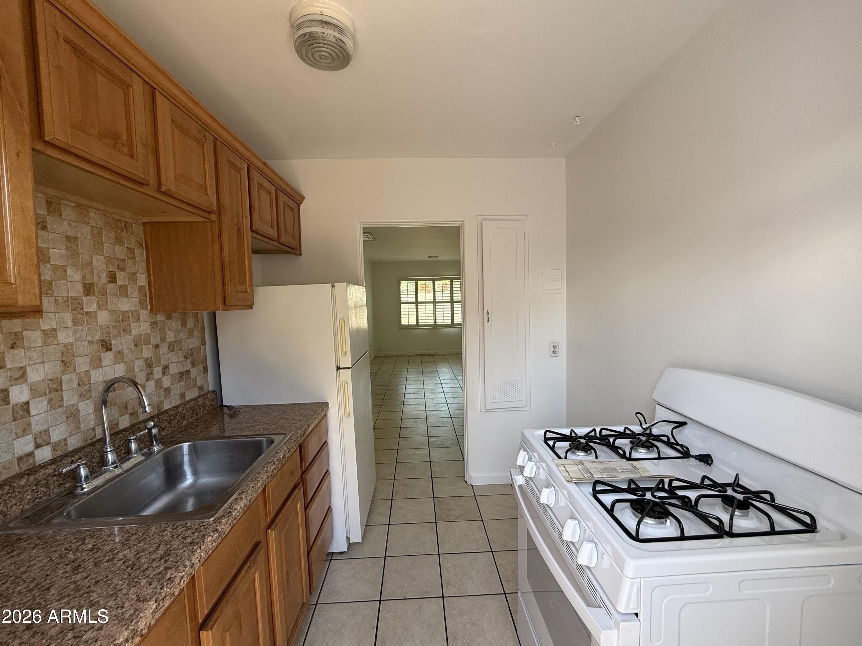1801 North 7th Avenue Phoenix, AZ 85003 - Photo 2 of 14 a kitchen with granite countertop a sink stove and cabinets